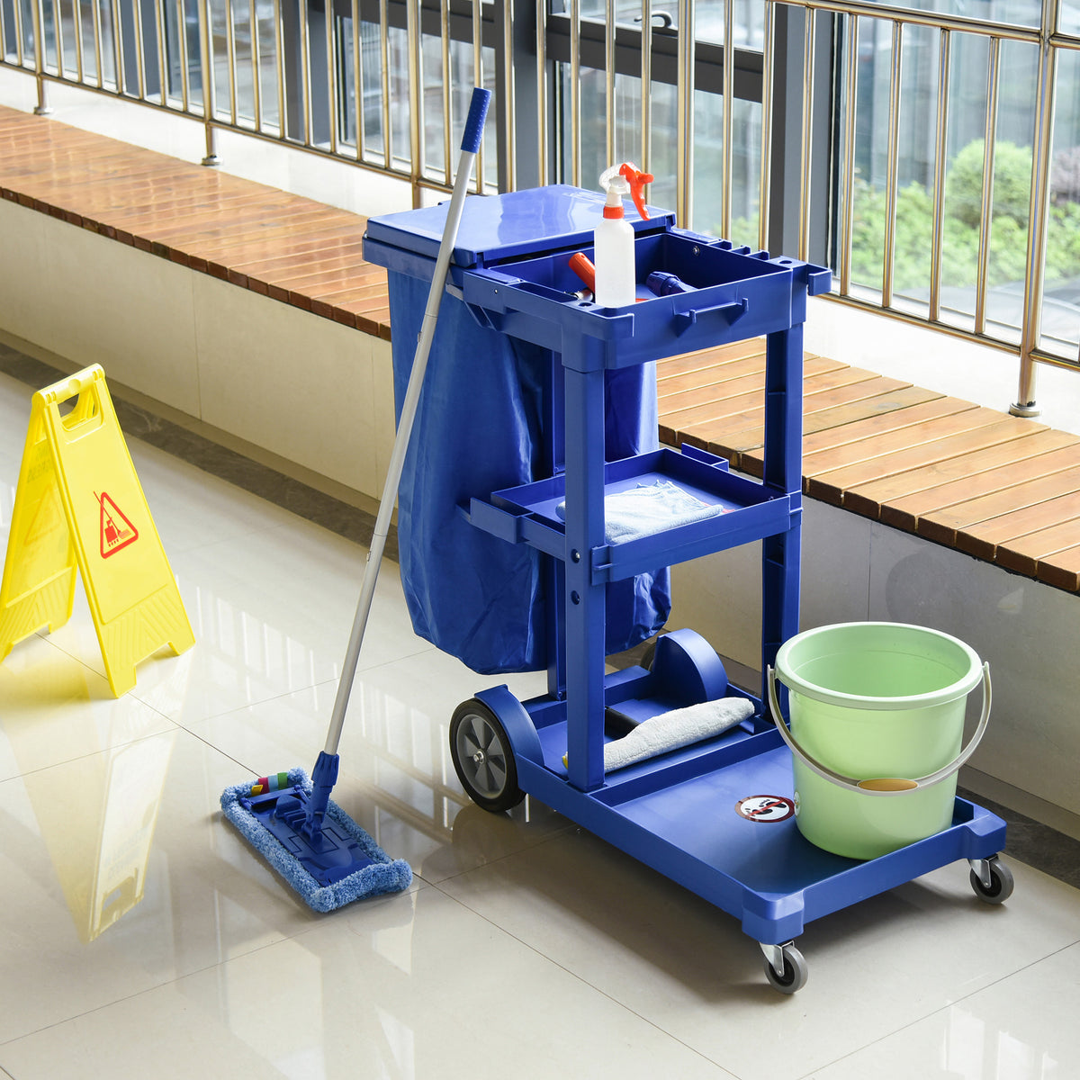 Blue cleaning cart with bucket and mop on a tiled floor