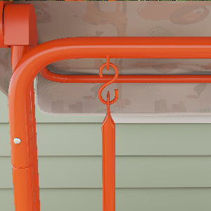 Orange metal chair with a hook on a green outdoor setting