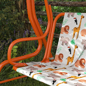 Orange chair with a white cushion featuring animal prints in a garden setting